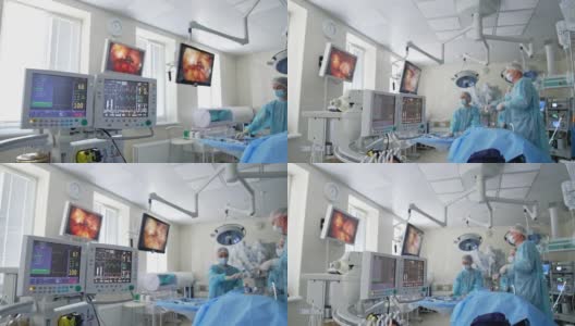 配有监护仪的现代化医疗手术室。监视器屏幕上的图形线显示手术期间病人的心电状况。高清在线视频素材下载