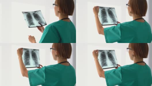 医生专业放射科检查，分析肺X线片。Spbas女人研究形象。电晕高清在线视频素材下载