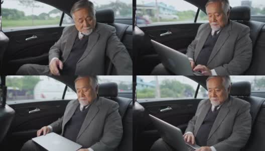 4K亚洲资深商人坐在汽车后座上工作的笔记本电脑高清在线视频素材下载