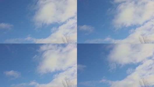 白云在蓝天上飘动。天气晴朗，飘着蓬松的云朵高清在线视频素材下载
