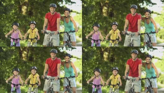 父母和他们的两个孩子骑自行车高清在线视频素材下载