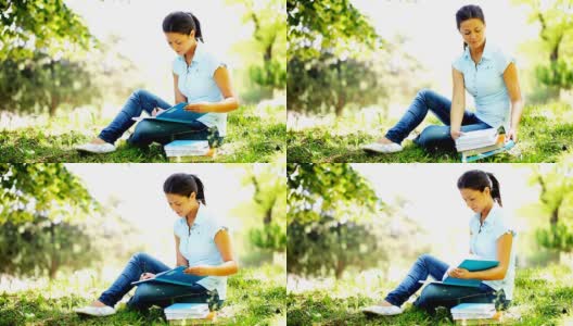 年轻的女学生在校外写作和学习。高清在线视频素材下载
