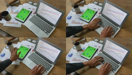 商人使用手机和数码平板电脑，绿屏高清在线视频素材下载