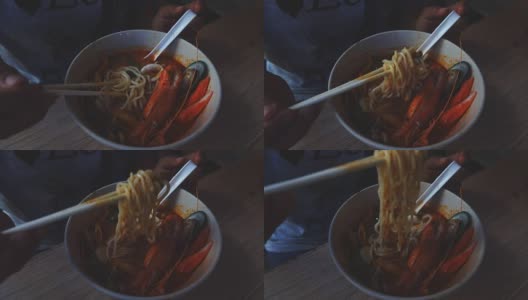 慢镜头:女子吃海鲜辣味面汤。高清在线视频素材下载