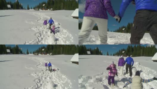HD CRANE:在雪中行走的家庭高清在线视频素材下载