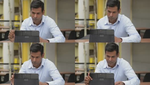 兴高采烈的印度商人在户外咖啡馆使用数字平板电脑高清在线视频素材下载