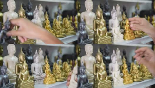 一名泰国游客在纪念品商店选购佛像。高清在线视频素材下载