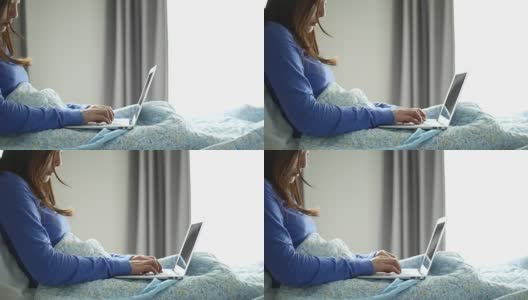 年轻女性在床上用笔记本电脑工作，在家工作高清在线视频素材下载