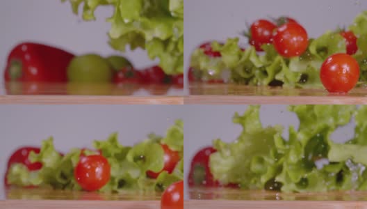 洗过的西红柿和卷心莴苣落在厨房的木台面上。高清在线视频素材下载
