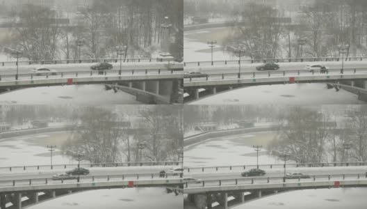 在爱沙尼亚的一个雪天，汽车沿着道路行驶高清在线视频素材下载