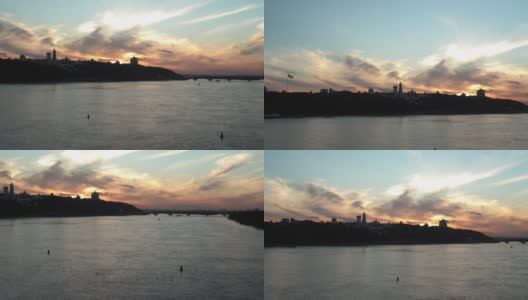 顶部鸟瞰图彩色的傍晚夏天天空。在日出日落时，在第聂伯洛河上的摩托艇和垂钓者。乌克兰基辅湖上的桥梁景观。水路运输、旅游高清在线视频素材下载