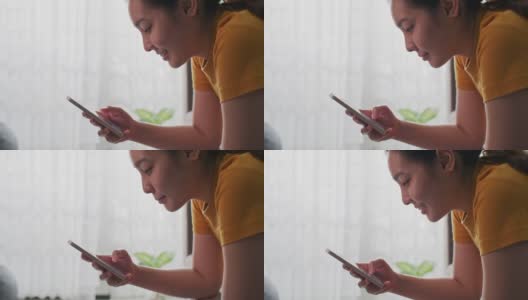 亚洲女性在家里使用手机高清在线视频素材下载