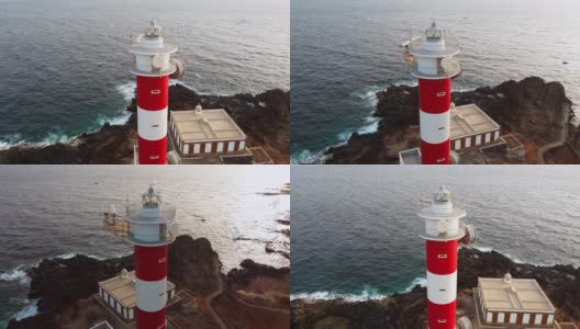 无人机观看-在特内里费岛岩石海岸的灯塔旁观看日落高清在线视频素材下载