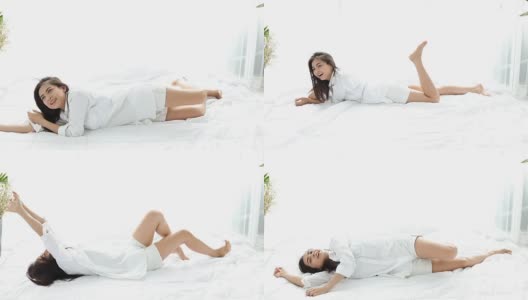 亚洲女人美丽的年轻微笑的女人坐在床上，伸展在卧室早上醒来后，在她的床上充分休息高清在线视频素材下载
