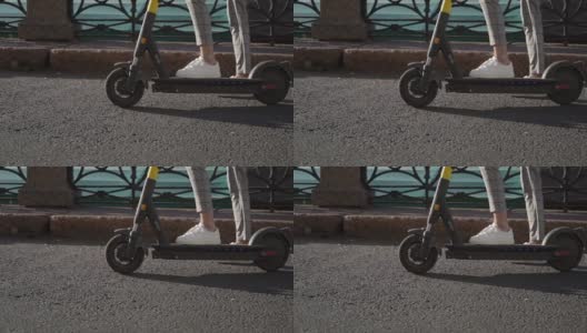 一个年轻人骑着一辆电动滑板车在城里转高清在线视频素材下载