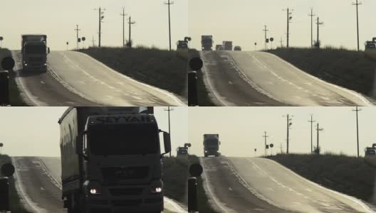重型卡车在铺好的道路上下降，形成一长列高清在线视频素材下载