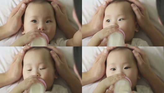 亚洲婴儿脸喝牛奶高清在线视频素材下载