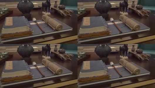 书籍和中国书法工具摆放在现代书房的书桌上高清在线视频素材下载