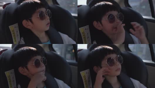 可爱的男孩坐在车里自驾游旅行高清在线视频素材下载