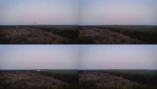 直升机在空中闪烁着侧灯，螺旋桨迅速旋转着飞向远方高清在线视频素材下载