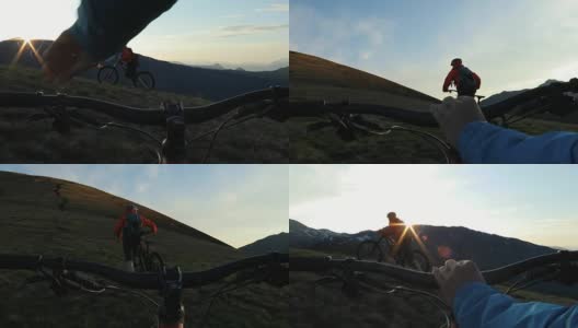 第一人称视角跟随另一个山地自行车手，因为他推动了在日出的高山斜坡。高清在线视频素材下载