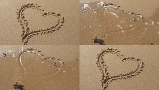 心的形状在沙子里，被潮水冲走。高清在线视频素材下载