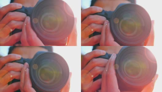 年轻男子在日落时用相机拍照的特写高清在线视频素材下载