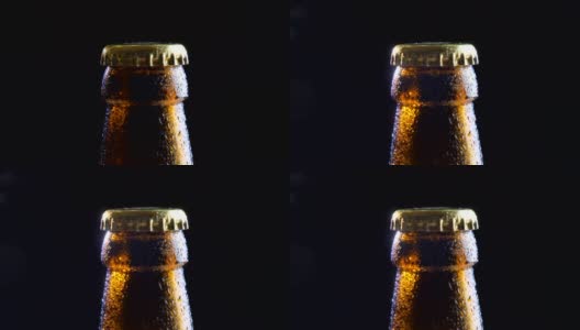 特写拍摄的啤酒瓶盖与背景孤立在黑色高清在线视频素材下载