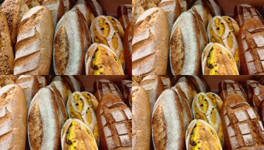 面包，小圆面包和其他烘焙产品的金色在商店货架上移动。高清在线视频素材下载