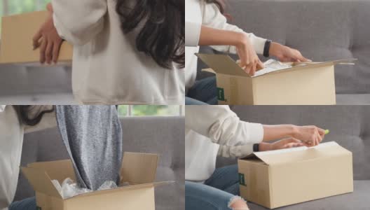 一名亚洲女子收到了网上购物商店的硬纸盒。一个女人走到沙发前，坐在客厅的沙发上拆邮包高清在线视频素材下载