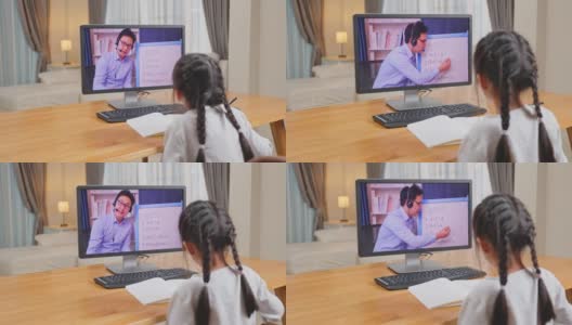 亚洲年轻女孩在网上看虚拟视频，在家里用笔记本电脑学习。由于covid - 19大流行，在家上学的孩子使用电脑学习，并通过数字远程会议听取学校老师的意见。高清在线视频素材下载