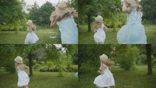 快乐的女孩在树林中奔跑，小女孩在绿色的花园中奔跑，孩子们梦想着高清在线视频素材下载