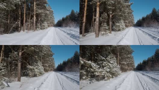 他的镜头沿着白雪覆盖的道路移动，在冬天的白桦林和绿色的松树高清在线视频素材下载