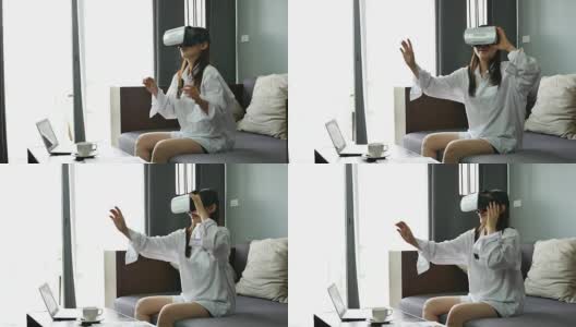 女性使用虚拟现实耳机与笔记本电脑在家，虚拟现实眼镜高清在线视频素材下载