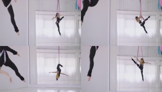 快乐迷人的年轻亚洲女运动员做反重力瑜伽练习，练习在空中吊床倒置的姿势。年轻漂亮的妇女穿着黑色运动服，在空中瑜伽的变化Chakrasana，桥式。高清在线视频素材下载