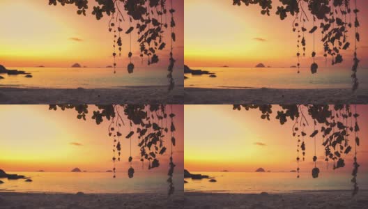 在马来西亚Perhentian岛的一个遥远的热带亚洲海滨沙滩上，有一棵巨大的树和全景海景，一个充满活力的红色日落和贝壳的Cinemagraph /无缝视频循环。蓝天碧水，风景秀丽，是旅游度假区。高清在线视频素材下载
