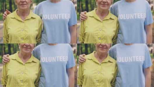 年轻的志愿者拥抱微笑的老女人，老人关怀，陪伴高清在线视频素材下载