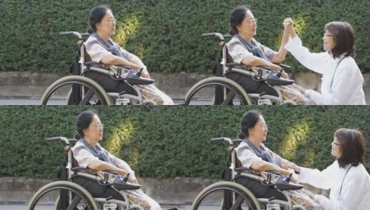 医生在轮椅上照顾老太太高清在线视频素材下载