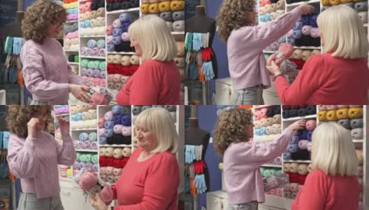 年轻的白人女售货员帮助女高级顾客选择羊毛的颜色高清在线视频素材下载