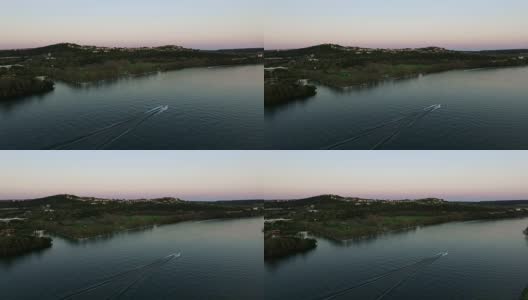 金星带的颜色地平线日落在德州山乡村大厦和德克萨斯州奥斯汀最好的地区，一艘快艇滑向水面市中心ATX高远角高清在线视频素材下载