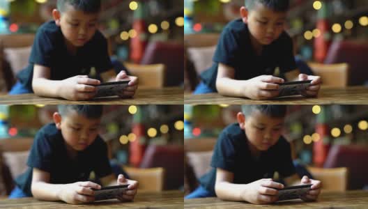 孩子们在咖啡馆里玩手机高清在线视频素材下载