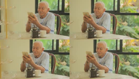 快乐的亚洲老人在家里用手机高清在线视频素材下载