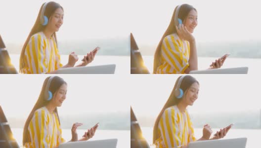 有吸引力的中国女性使用无线耳机和智能手机，快乐脸女人听喜欢的歌曲，跳舞，唱歌在舒适的阳光透过女人的背面。幸福的时刻高清在线视频素材下载