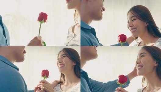 亚洲青年惊喜送玫瑰给美丽的女友。迷人浪漫的新婚男女花时间在房子里一起庆祝周年纪念日和情人节。高清在线视频素材下载