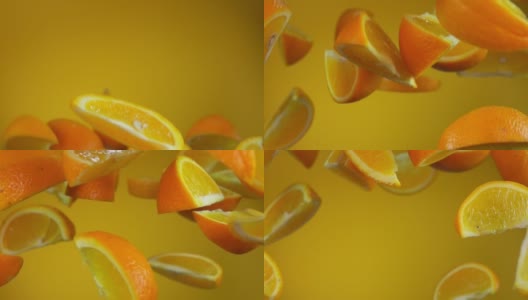 多汁美味的熟透的橘子片在黄色的背景上跳跃高清在线视频素材下载