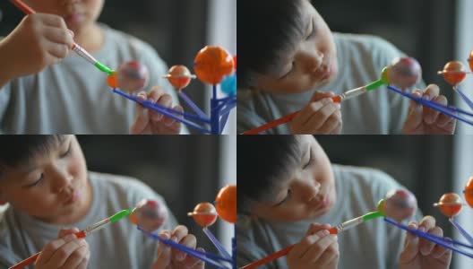 亚洲男孩画太阳系模型。创造性和学习的概念高清在线视频素材下载