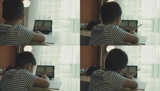 一个亚洲男孩在家参加在线课程。高清在线视频素材下载