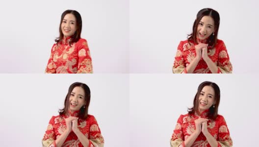 年轻的亚洲女性穿着红色旗袍，在中国新年当天表现出尊敬和问候高清在线视频素材下载
