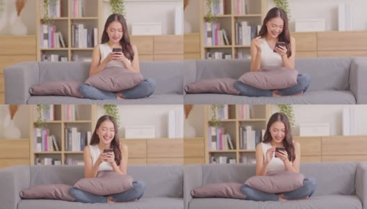 幸福企业家美丽的商业亚洲年轻女性穿休闲使用手机，网上购物，笑享受与社交媒体和笔记本电脑在家里。小型创业。网上银行高清在线视频素材下载