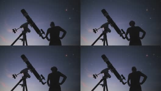 一个男人的剪影，望远镜和星空下的乡村。高清在线视频素材下载